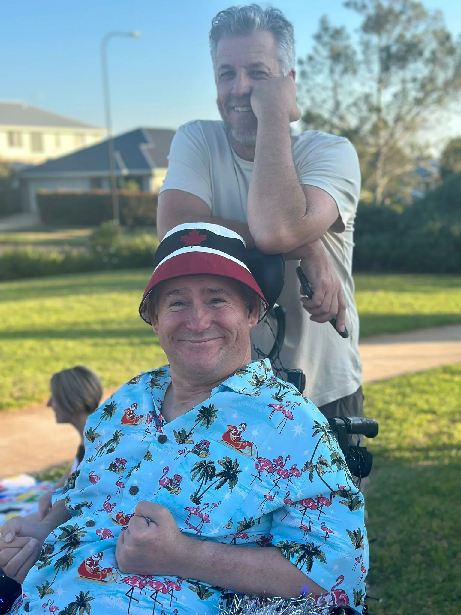 A participant and support worker enjoying golden hour at the park