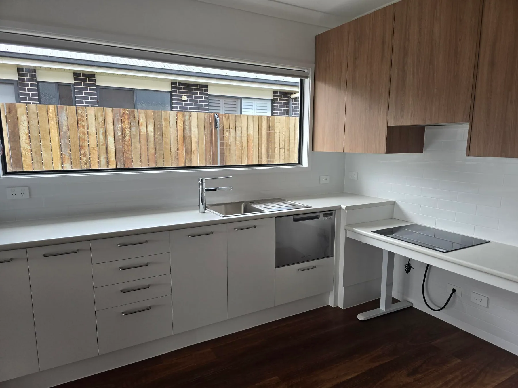 The kitchen of the Highfields SDA home, with a cooktop on an adjustable-height bench